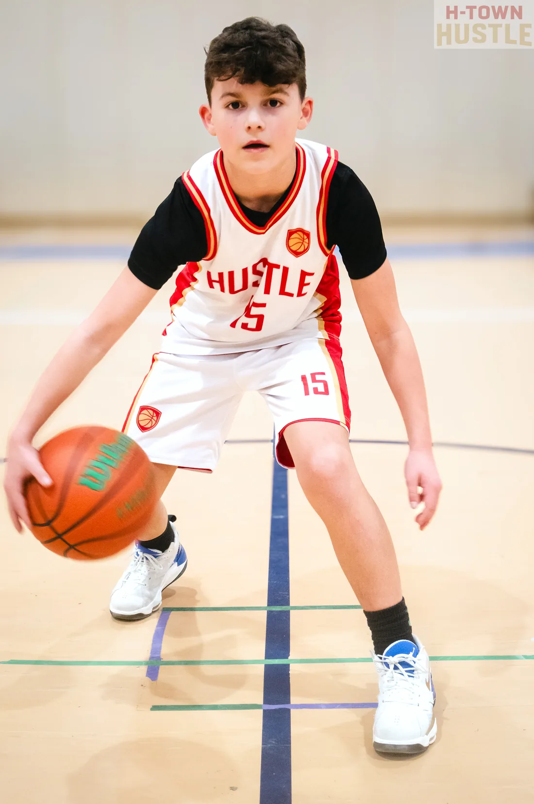 H-Town Hustle player dribbling on the basketball court